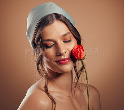 Buy stock photo Rose, woman and face for beauty, natural skincare and cosmetics for floral perfume, aesthetic and eco makeup on studio background. Headshot, model and flowers of nature, spring plants and body glow 