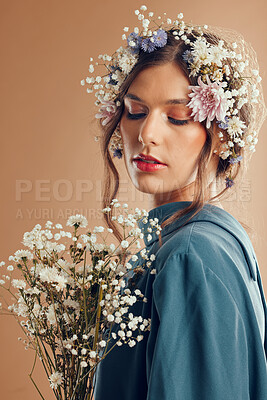 Buy stock photo Beauty, makeup and woman with flower, crown and skincare in studio, wellness and creative on brown background mockup. Flowers, girl and model with nature aesthetic, luxury and eco friendly product 