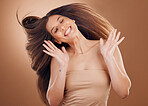 Woman, hands and hair flip for beauty in studio or hair cosmetics wellness, natural growth and luxury hair care treatment. Model, shampoo dermatology and sknicare glow or salon therapy treatment