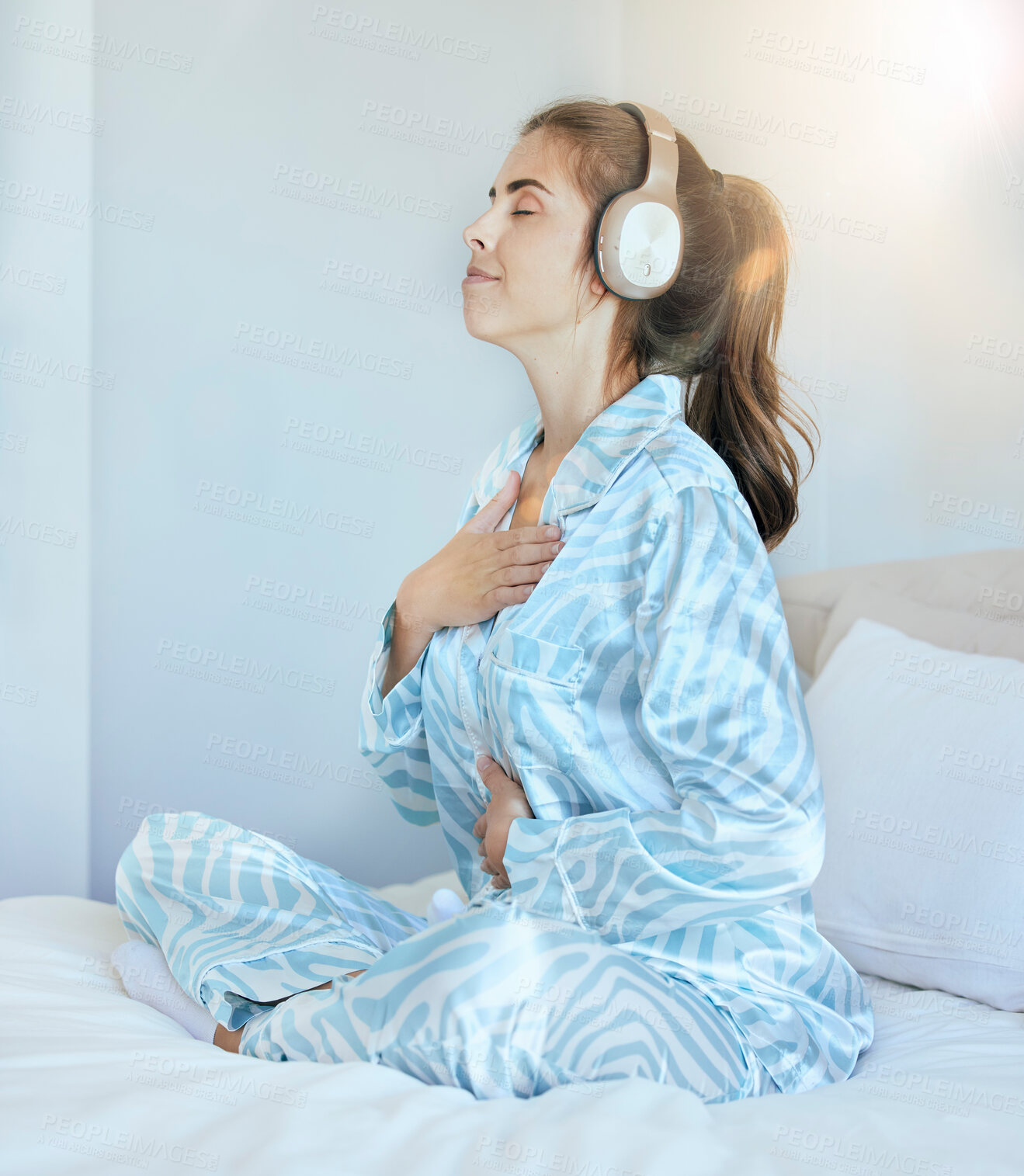 Buy stock photo Woman, morning and headphones for meditation on bed while listening to music or podcast while breathing for chakra exercise in bedroom. Female at home with pajamas with audio for mental health
