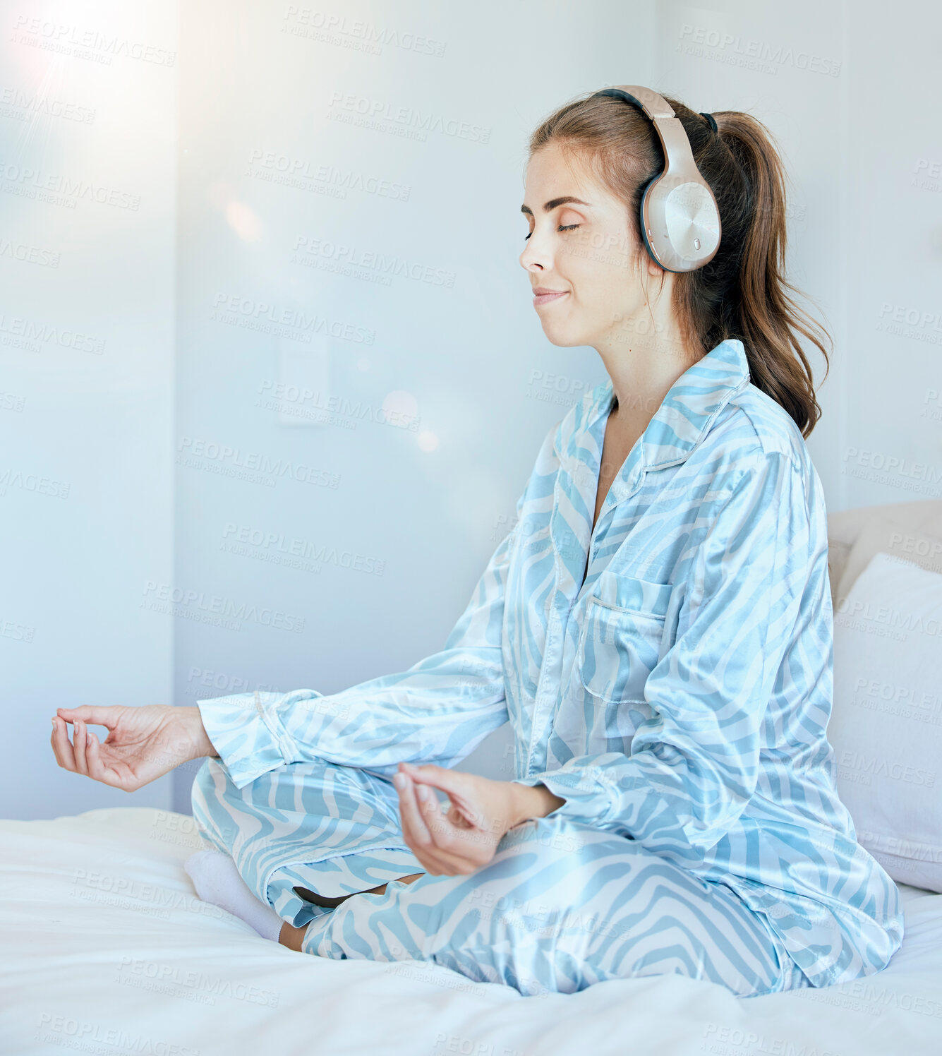 Buy stock photo Yoga, meditation or zen woman in bedroom with headphones streaming relaxing radio, calm music or podcast. Peace, mental health or spiritual girl in lotus pose to meditate for mindfulness or wellness