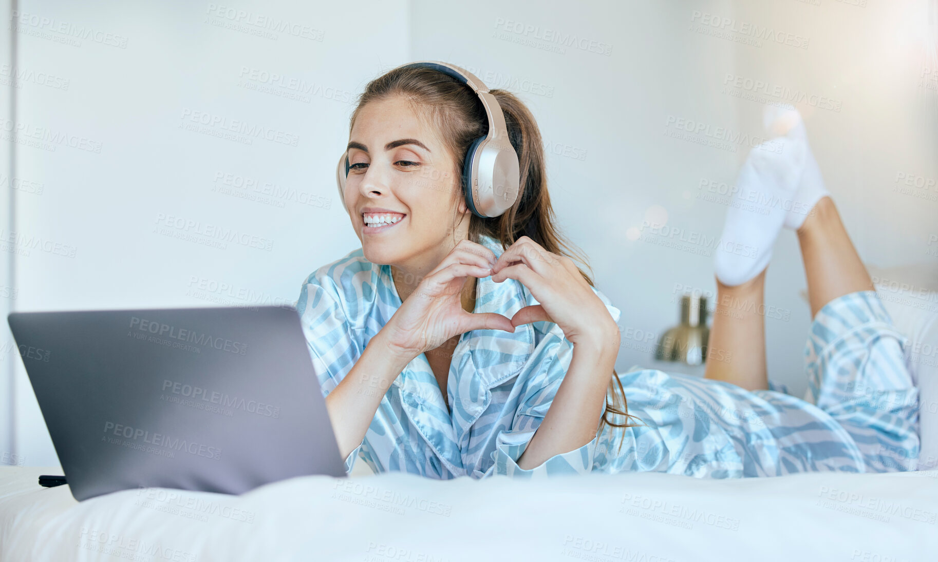 Buy stock photo Woman, video call and heart hand sign of a person in the morning with headphones on a computer. Bedroom bed, smile and happiness of a female in a home feeling happy and relax on digital communication