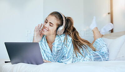 Buy stock photo Woman, headphones and relax on laptop in bedroom to download movies, online show and media entertainment at home. Happy young female, music and computer for streaming subscription, podcast and audio