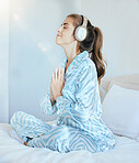 Woman, headphones and morning meditation in bedroom for wellness, mindfulness and chakra energy, zen fitness or peace. Happy girl, yoga exercise and music for namaste prayer, mindset or mental health