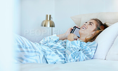 Buy stock photo Woman, phone call and bed in the morning, happy and conversation. Female, smartphone and girl in bedroom, talking and smile for weekend break, communication and wifi connectivity to relax and call
