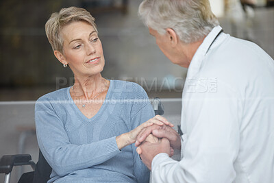 Buy stock photo Disability patient, holding hands and doctor with help, support and trust in physical therapy, healthcare and therapy service. Medical worker, empathy hand holding and consulting woman in wheelchair