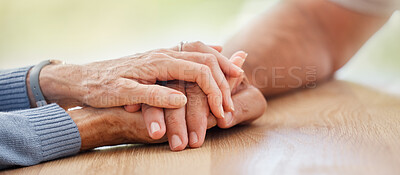 Buy stock photo Senior, holding hands and support with couple, comfort and help on table for grief, pain or sympathy. Elderly man, old woman and helping hand for empathy, love and care in home with bonding together