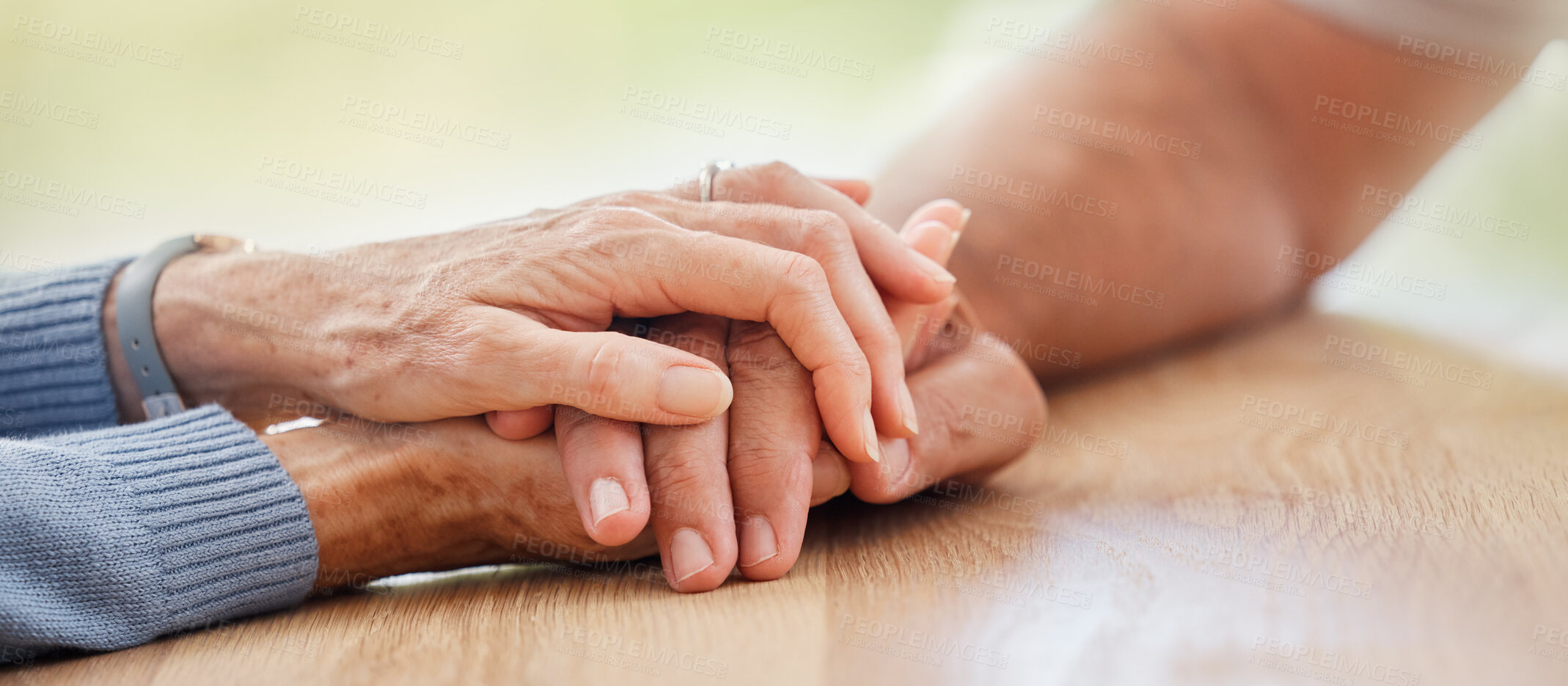 Buy stock photo Senior, holding hands and support with couple, comfort and help on table for grief, pain or sympathy. Elderly man, old woman and helping hand for empathy, love and care in home with bonding together