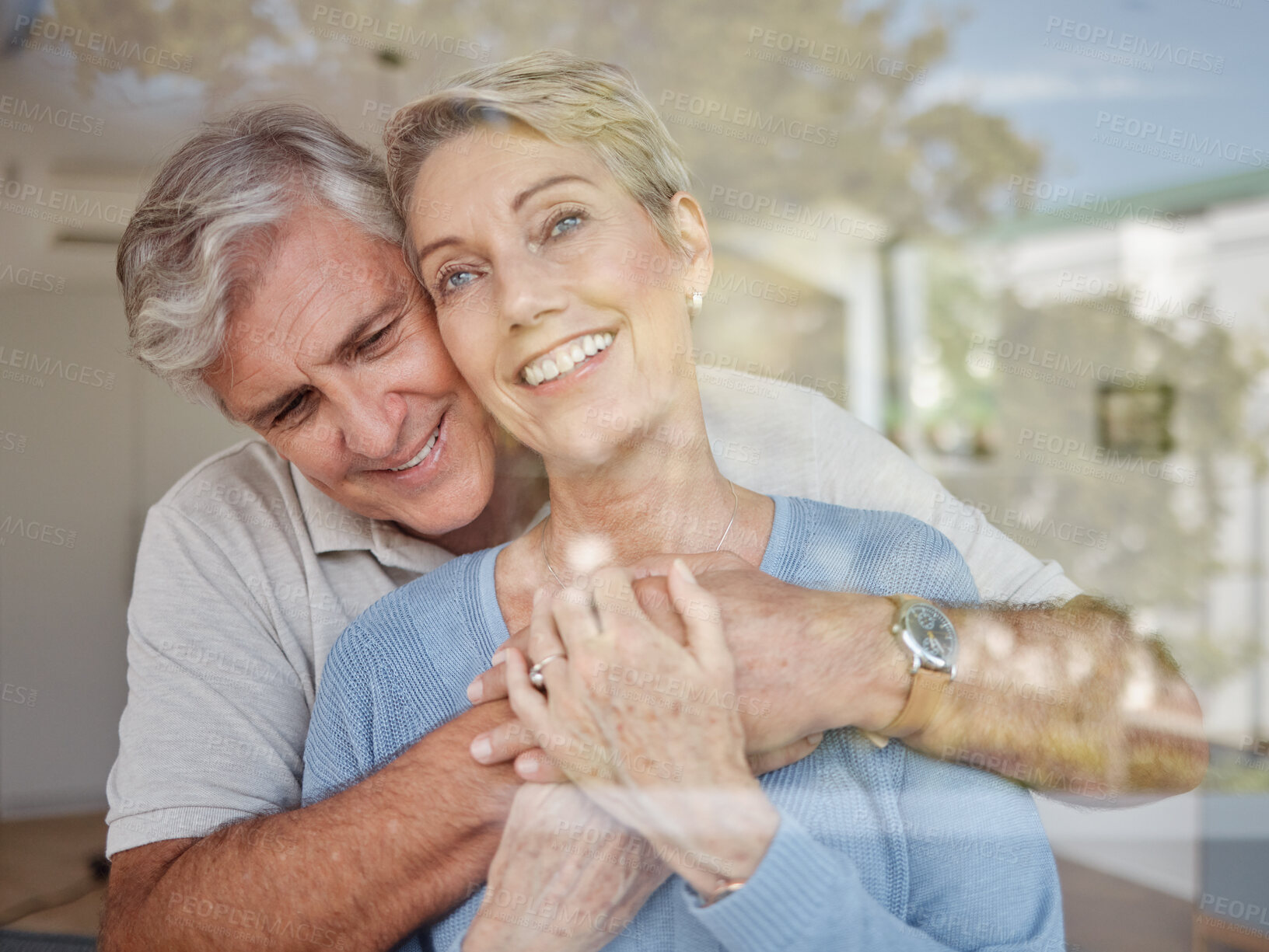 Buy stock photo Love, window and senior couple hug, happy and bonding together for marriage, wellness and smile. Romantic, mature male and elderly female embrace, loving for anniversary and enjoy retirement at home.