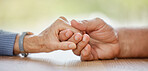 Elderly couple, holding hands and support for comfort, love or help on table for compassion, pain or sympathy. Senior man, old woman and helping hand with empathy, trust and care in home for bonding