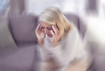 Senior woman, headache and sofa in home with motion blur, pain and depressed while tired in retirement. Elderly, old woman and anxiety with burnout, depression and panic attack on couch at house