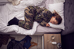 Depression, anxiety and woman soldier in bed with ptsd, trauma and pills for suicide, phobia and mental health. Stress, thinking and army girl suffer with insomnia, drug addiction and fear in bedroom