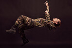 Anxiety, soldier and woman in studio for war ptsd, nightmare and horror, mental health and depression on black background. Military, flashback and girl in army crisis, trauma and fall Ukraine veteran