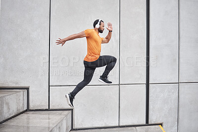 Buy stock photo Fitness, running and man with headphone on stairs for exercise, workout and wellness, body goals and health on music app. Sports, athlete or runner jump or run listening to audio and training in city