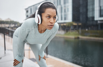 Buy stock photo Headphones, fitness and runner woman on a urban street with motivation, music and exercise. City run, sport and marathon training workout of a black woman athlete listening to web radio for sports