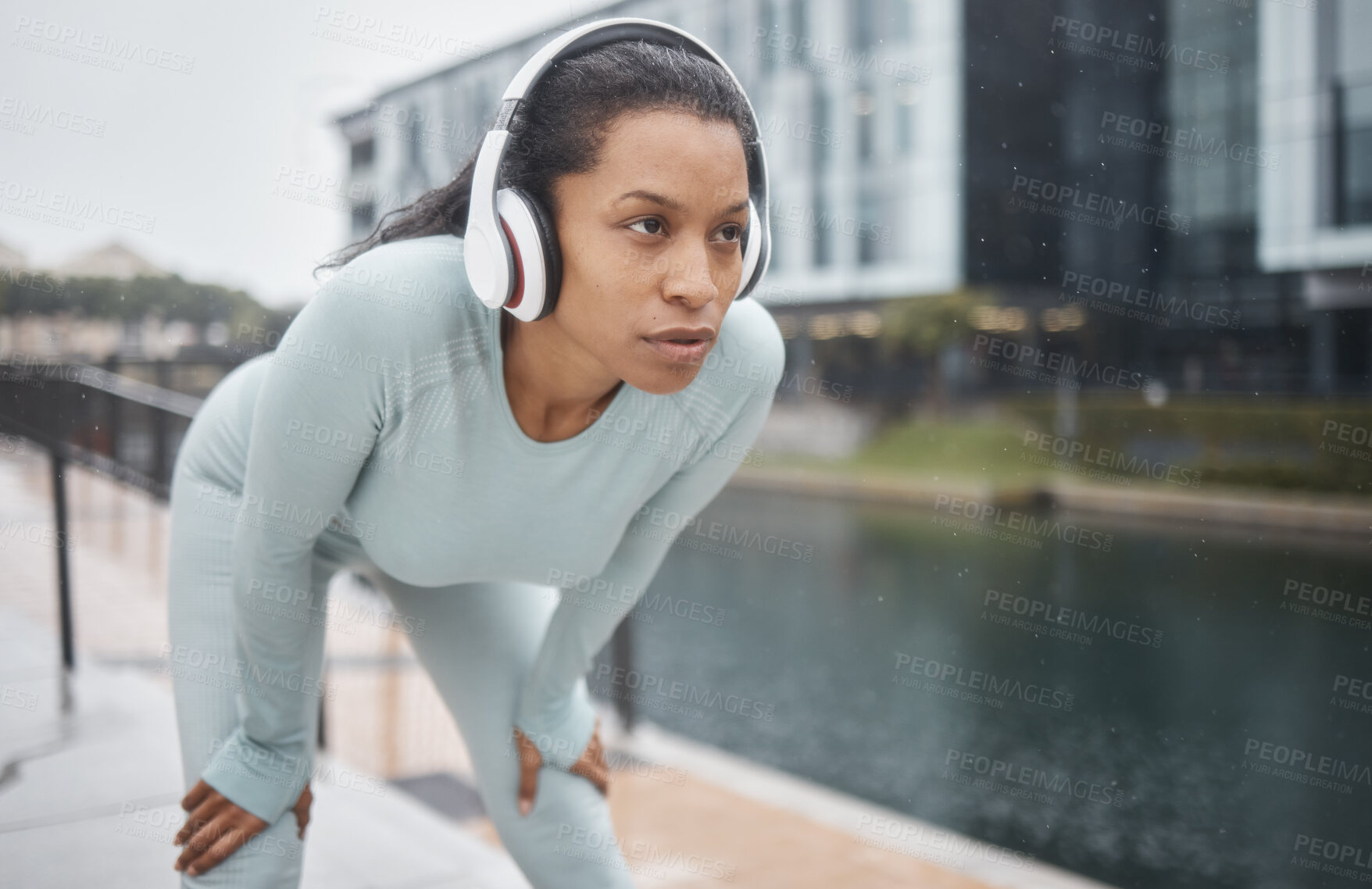 Buy stock photo Headphones, fitness and runner woman on a urban street with motivation, music and exercise. City run, sport and marathon training workout of a black woman athlete listening to web radio for sports