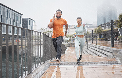 Buy stock photo Fitness, city and couple in the rain running for workout, marathon training and exercise in winter. Sports, wellness and man and woman run for endurance, challenge and body performance in urban town