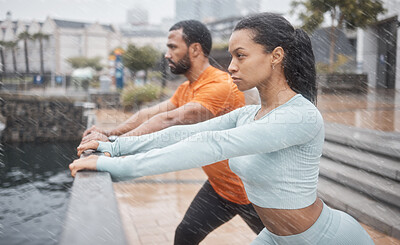 Buy stock photo Workout, stretching and couple of friends training with focus before running in the rain. Urban, runner athlete and sports exercise in winter of black people with motivation in the city for fitness