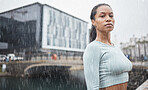 Fitness, motivation and black woman in rain in city for workout, marathon training and running. Sports, winter and portrait of female athlete exercise for healthy lifestyle, wellness and inspiration