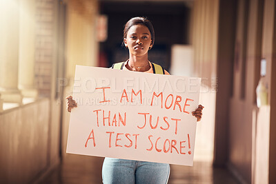 Buy stock photo Education, protest and student with a poster at a college for scholarship, debt and school loans. Justice, freedom and black woman standing with a sign on the university, school or academic campus.