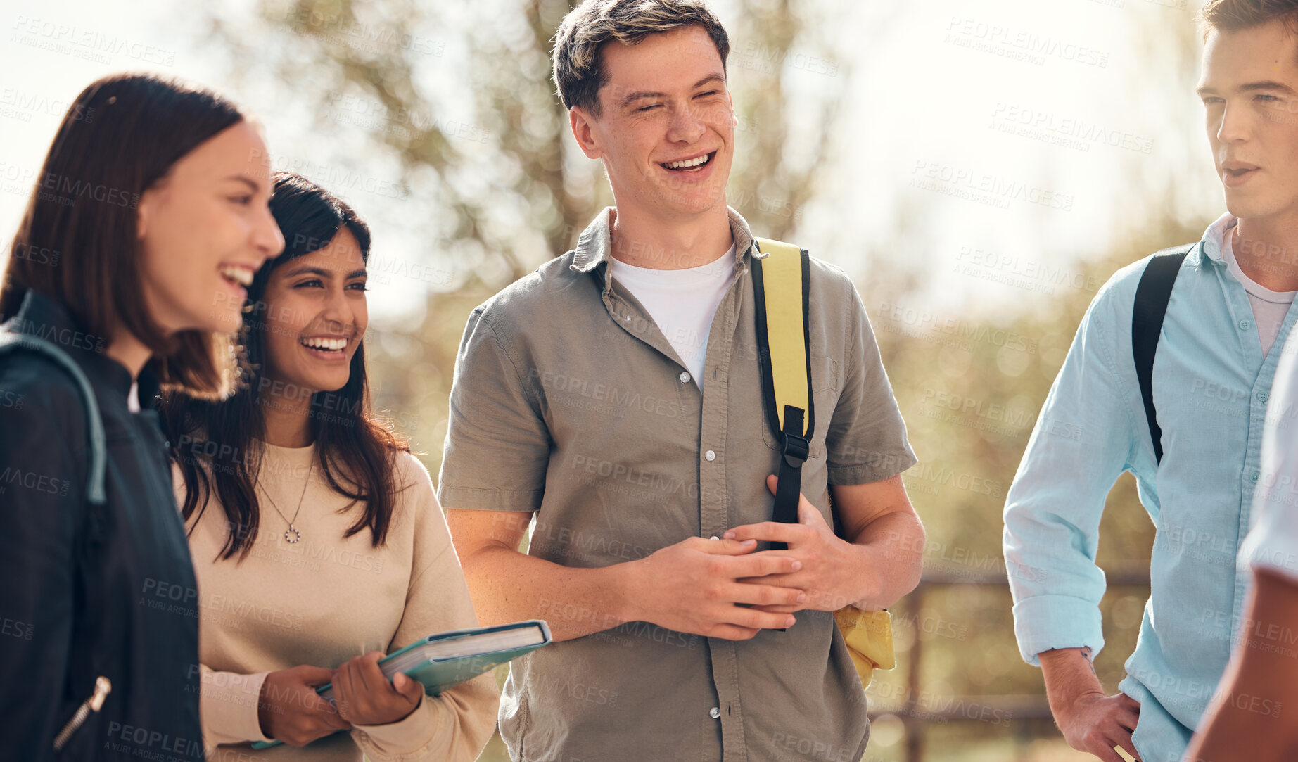 Buy stock photo Group of friends, students and conversation outdoor, relax and happy together. Young people, standing in circle and talking on campus, bonding and enjoy break in nature, discussion for test and laugh