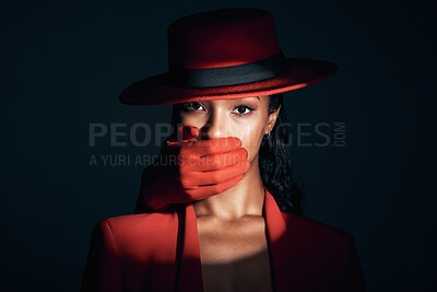 Buy stock photo Fashion, spotlight and hand over mouth for secret and power of strong woman portrait in dark studio for beauty, sale announcement or freedom voice. Face of 90s retro cosmetic model in red for abuse