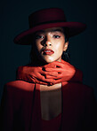 Beauty, makeup and fashion of a black woman in dark studio with spotlight on face for cosmetics, designer brand clothes and art deco. Portrait of London model with red lipstick and hand glove on neck