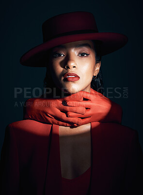Buy stock photo Beauty, makeup and fashion of a black woman in dark studio with spotlight on face for cosmetics, designer brand clothes and art deco. Portrait of London model with red lipstick and hand glove on neck