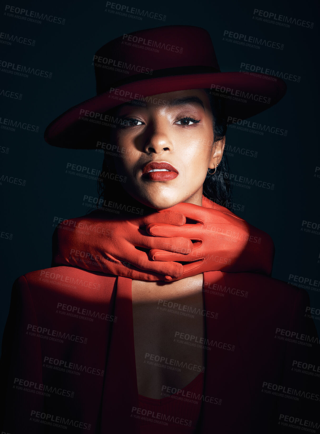 Buy stock photo Beauty, makeup and fashion of a black woman in dark studio with spotlight on face for cosmetics, designer brand clothes and art deco. Portrait of London model with red lipstick and hand glove on neck