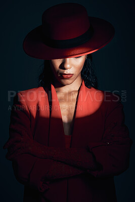 Buy stock photo Fashion, red suit with spotlight for woman in dark, mystery and 90s retro on a black studio background. Designer, power and model with vintage clothes, arms crossed and makeup for empowerment