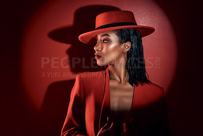 Buy stock photo Fashion, spotlight and woman in red suit, vintage clothing or retro outfit. Thinking, aesthetic and stylish, confident and classy female model in 90s designer hat isolated on a dark studio background