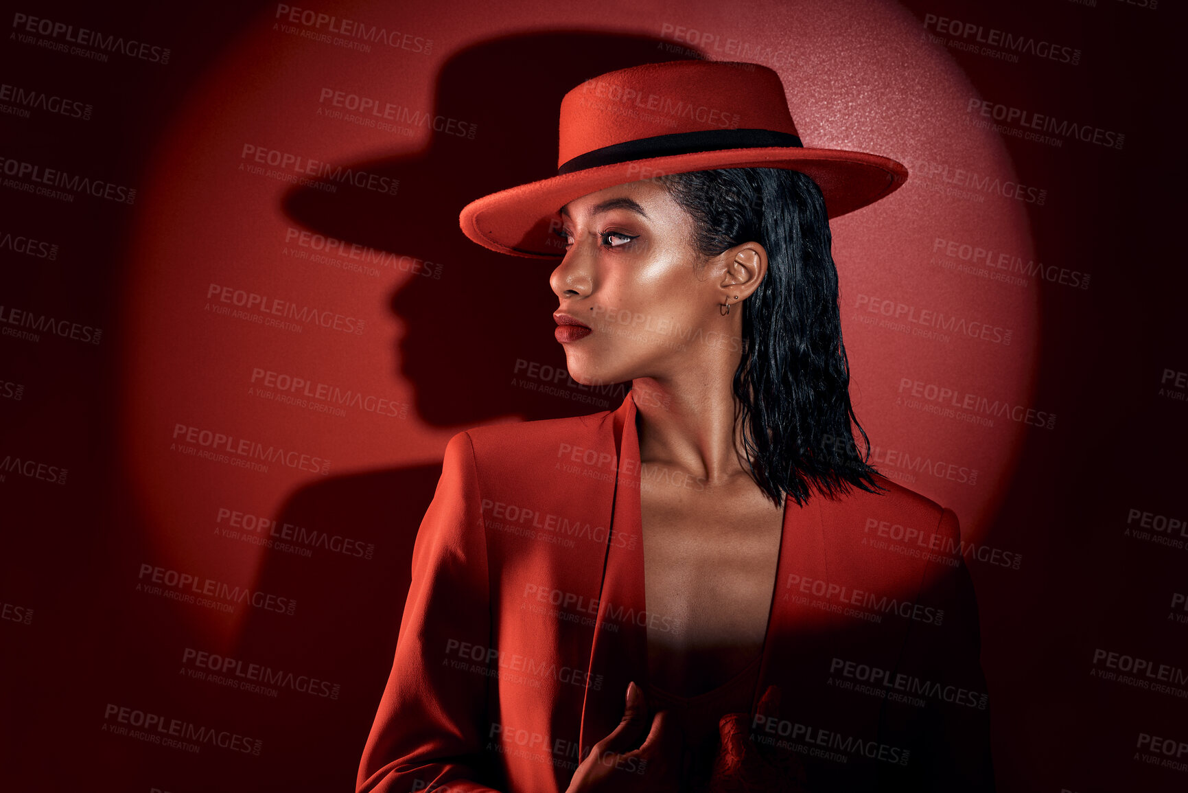 Buy stock photo Fashion, spotlight and woman in red suit, vintage clothing or retro outfit. Thinking, aesthetic and stylish, confident and classy female model in 90s designer hat isolated on a dark studio background