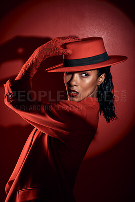 Buy stock photo Fashion, spotlight and model with red suit, luxury clothes or designer brand apparel for aesthetic 90s style on studio background. Mystery, dark beauty or retro black woman with creative shadow light