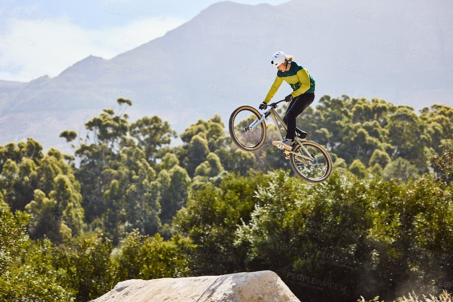 Buy stock photo Mountain biking, sports and man training in nature, cycling energy and in air for a competition in Turkey. Exercise, danger and athlete with a mountain bike for fitness, speed and jump during contest