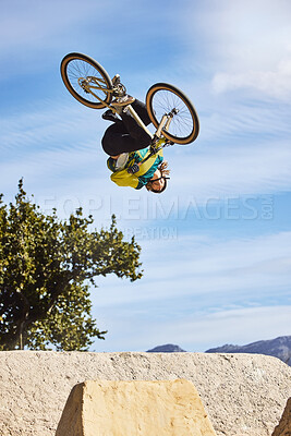 Buy stock photo Cycling sports, bike and jump of man performing stunt outdoors in nature. Trick, dangerous risk and biker, rider or bmx athlete on bicycle jumping on ramp for training exercise, workout and fitness