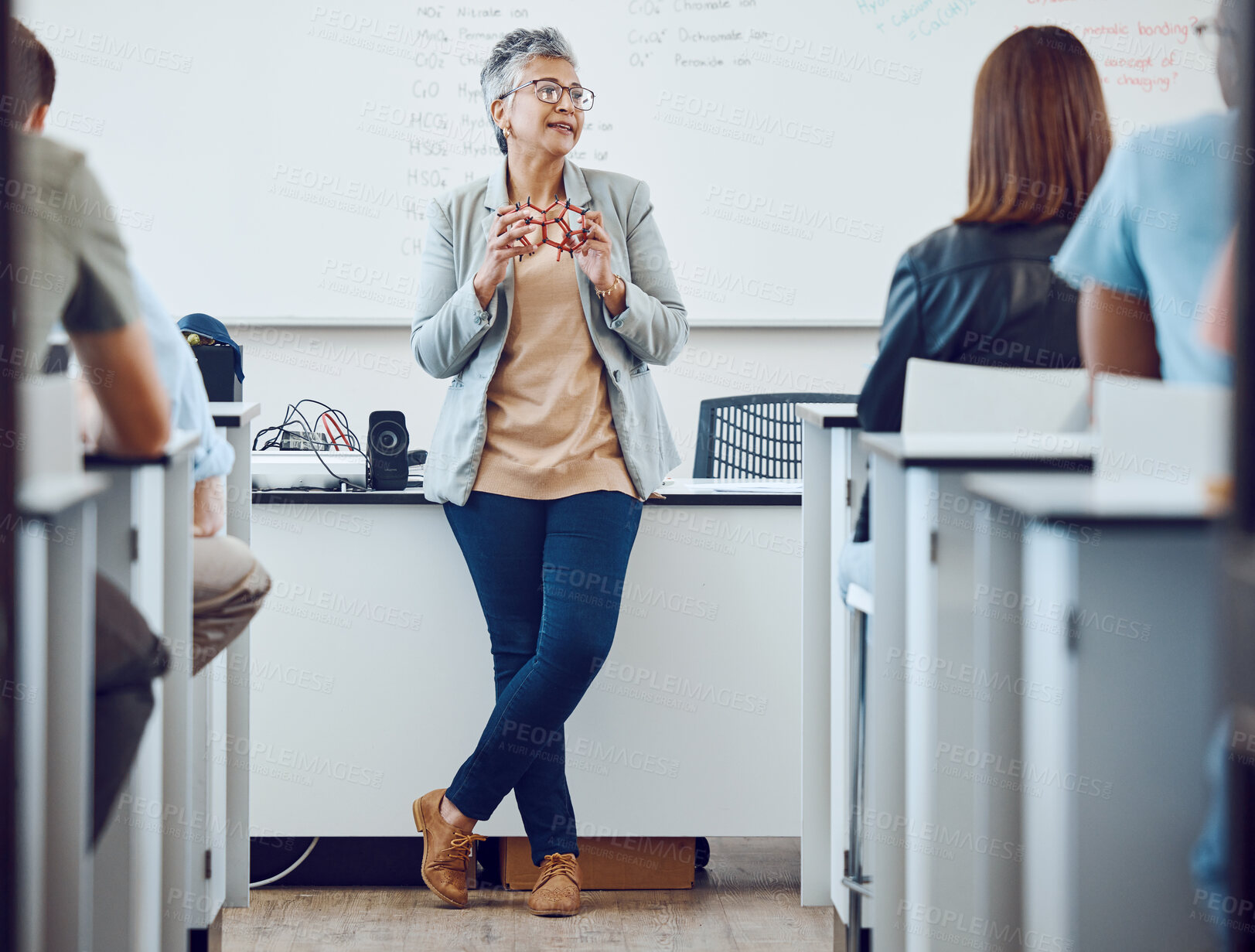 Buy stock photo Classroom, presentation and science professor at university of physics or dna model in education, learning and teaching on whiteboard. Students in desk, teacher, leader or presenter woman in college