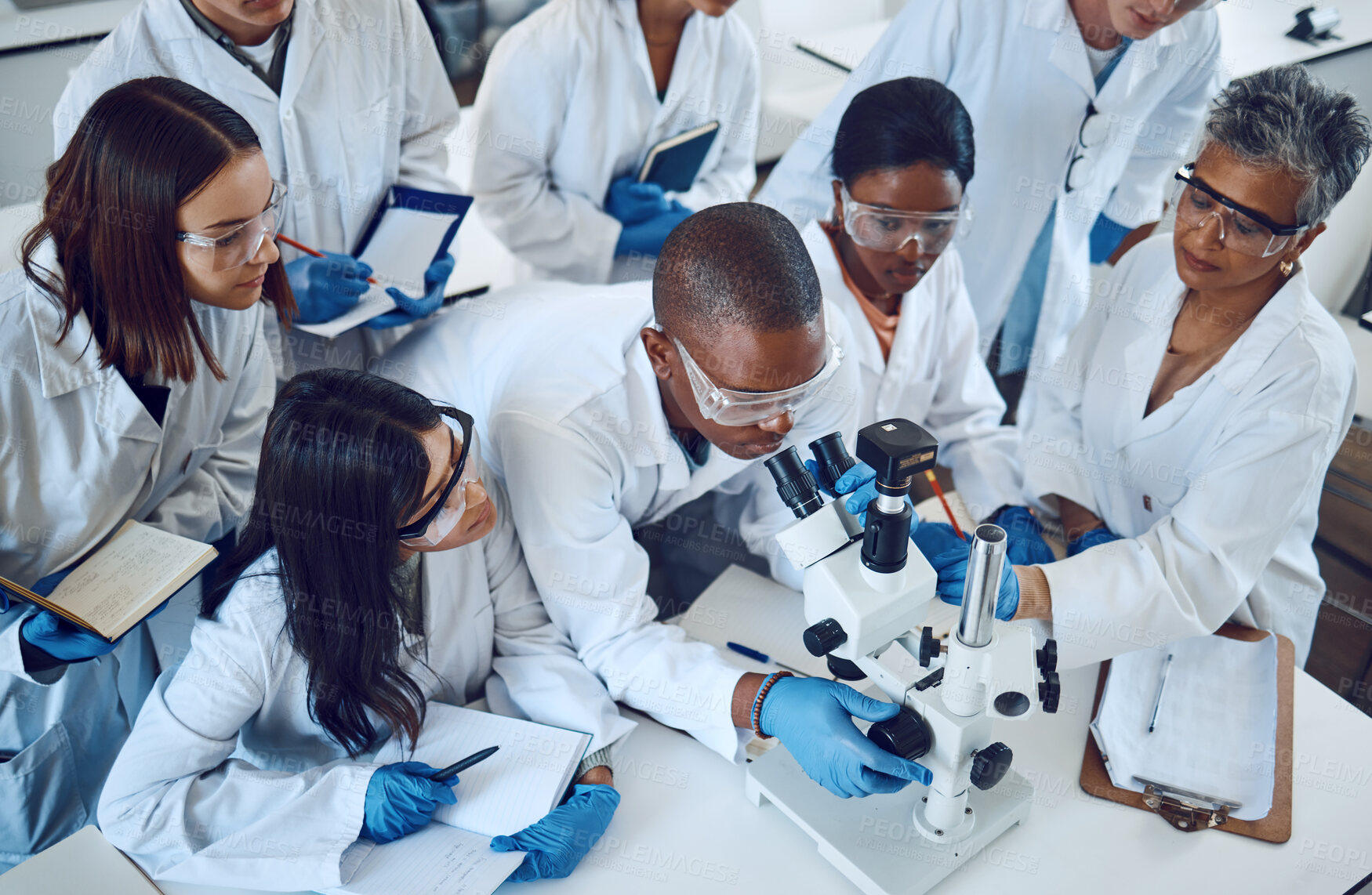 Buy stock photo Student, microscope and science in university class, group and learning with woman lecturer, education or study. Students, scientist and medical research, dna lab or scholarship innovation at college