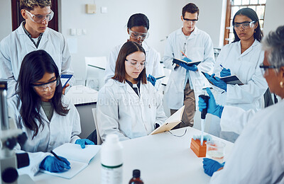 Buy stock photo Science, students and education in a medical laboratory writing notes during scientist lecture or lesson with mentor or teacher. Medical men and women for training and learning in chemistry class