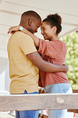 Buy stock photo Black couple, love hug and relax in home patio, smiling and bonding. Support, affection and happy man and woman hugging, embrace or cuddle face to face, having fun and enjoying quality time together.
