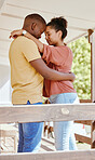 Black couple, love and hug while outdoor on patio at. home while together for trust, support and care in a healthy marriage. Man and woman with gratitude, commitment and happiness while on holiday