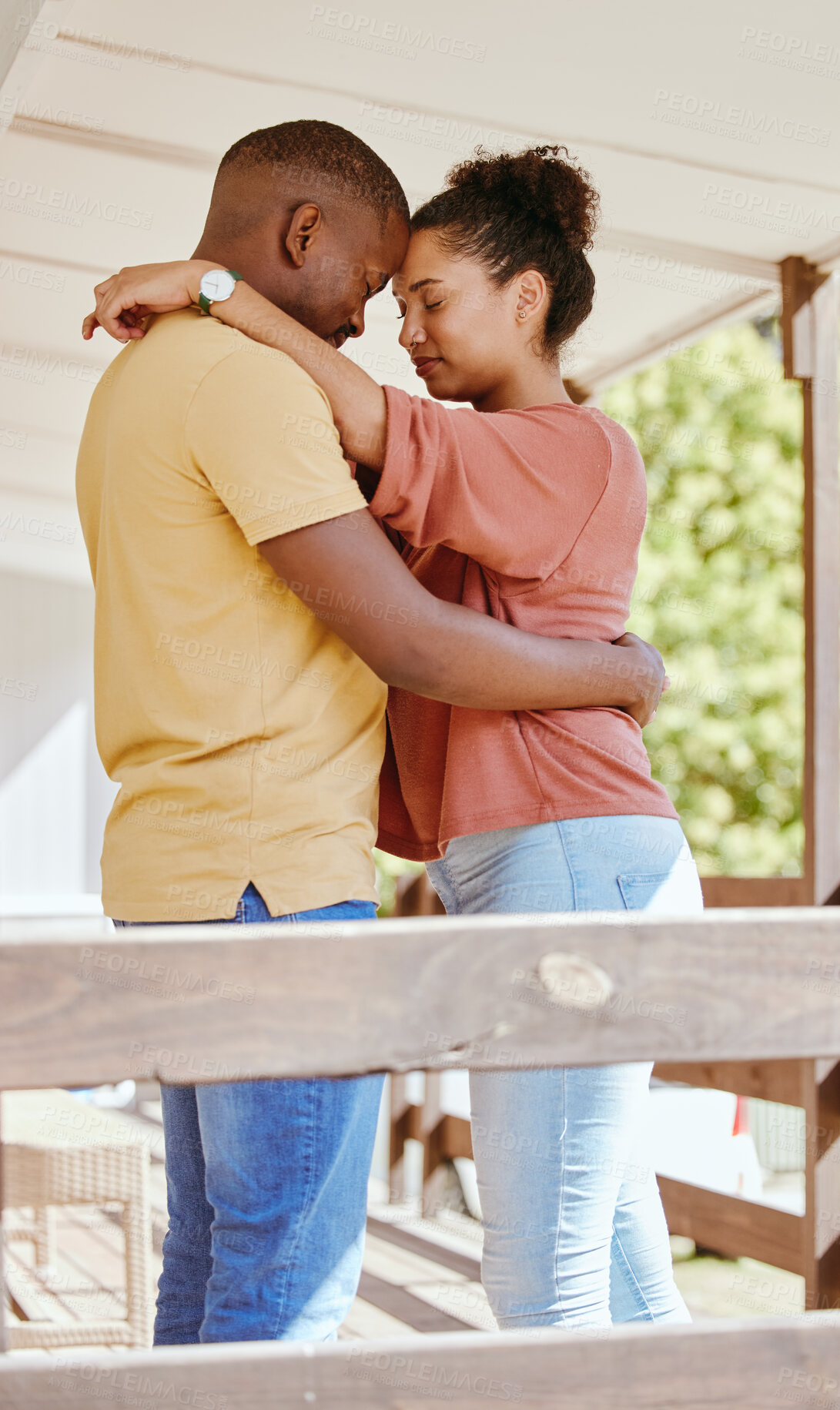 Buy stock photo Black couple, love and hug while outdoor on patio at. home while together for trust, support and care in a healthy marriage. Man and woman with gratitude, commitment and happiness while on holiday