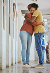 Hug, animal shelter and adoption with a black couple together in a rescue center for foster care. Hugging, volunteer and charity with a man and woman doing charity or relief work while bonding