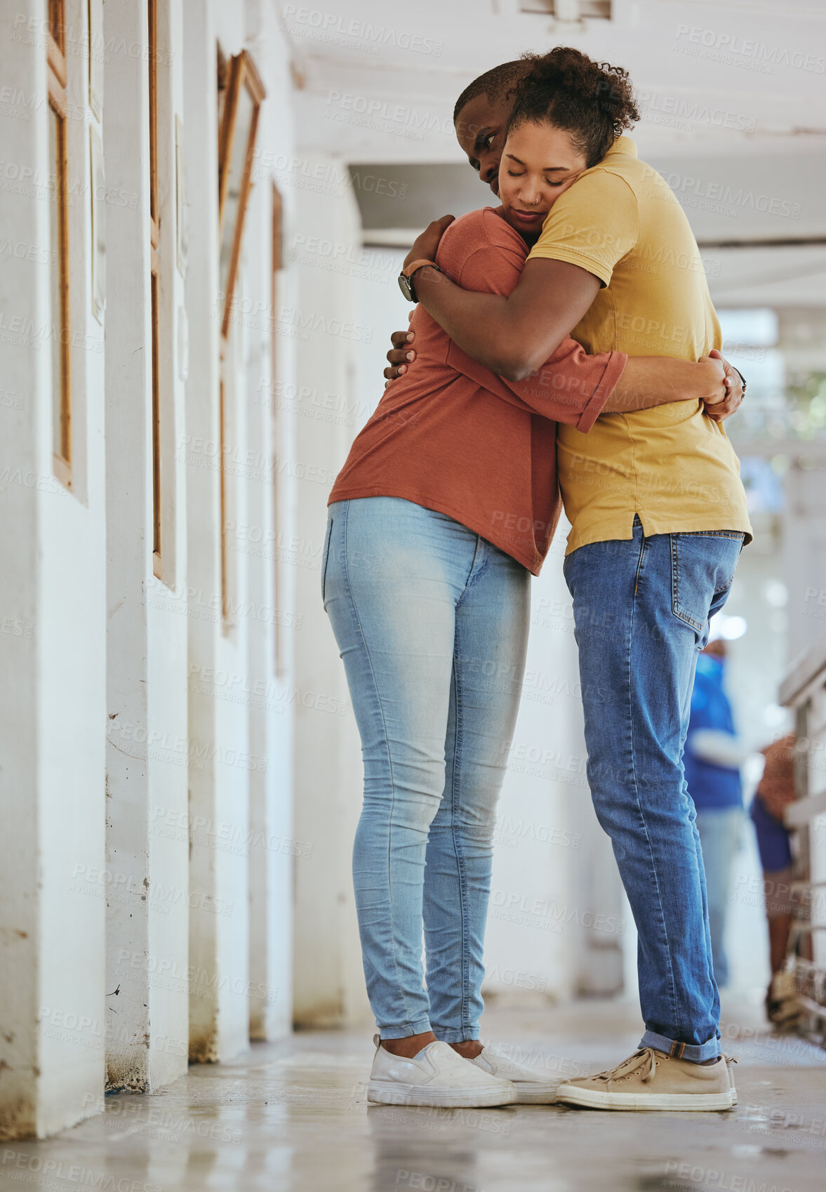 Buy stock photo Hug, animal shelter and adoption with a black couple together in a rescue center for foster care. Hugging, volunteer and charity with a man and woman doing charity or relief work while bonding