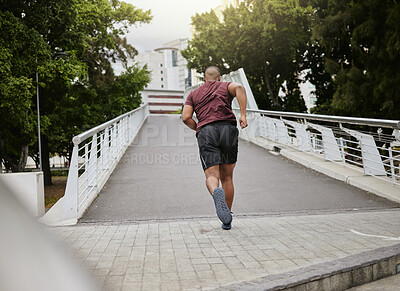 Buy stock photo Fitness, exercise or black man running on bridge in city, street or road for wellness, cardio training or workout. Sports, back view or runner in New York for health goal, marathon or race event