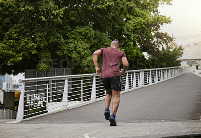 Buy stock photo Fitness, running and man on a bridge for training, wellness and cardio in a city, cardio and energy. Sports, runner and male exercise on a highway for run, challenge and body performance goals 