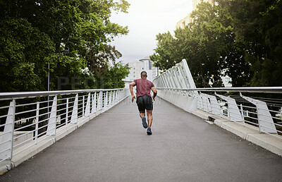 Buy stock photo Fitness, man and running in the city park for healthy exercise, cardio workout or training in the outdoors. Active athletic male runner in sports activity, run or exercising outside on city bridge