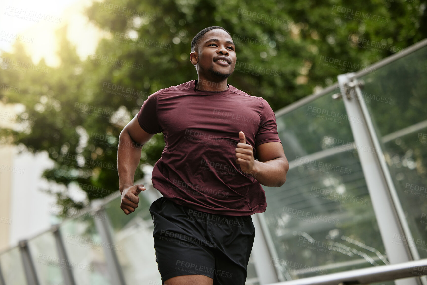 Buy stock photo Black man, fitness and running in park for healthy workout, exercise or cardio in the nature outdoors. Happy African American male runner enjoying a jog, run or exercising for health and wellness
