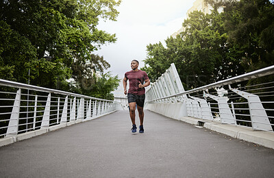Buy stock photo Running, bridge and black man athlete training for marathon run, wellness and sports. Speed cardio, runner workout and fitness workout of a man doing health exercise on a urban road in the morning