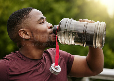 Buy stock photo Fitness, nature and man drinking water after a workout in a park for hydration, thirst and rest. Sports, runner and healthy African male athlete enjoying a beverage during cardio exercise or training