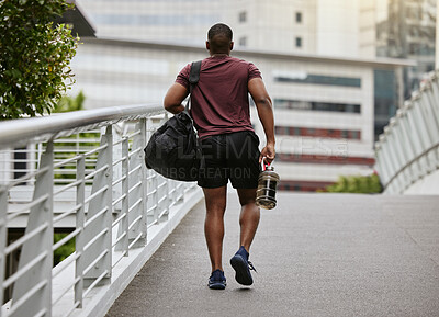 Buy stock photo Fitness, health and man walking to gym with bag and water bottle ready for training or exercise workout. Motivation, bodybuilding and sports, strong black man athlete on street in city with gym bag.